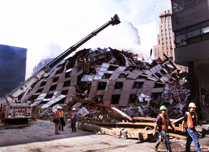Firefighters hose down the smoldering remains of 7 World Trade Center Tuesday, Sept. 18, 2001, in New York. Ryan Remiorz | AP