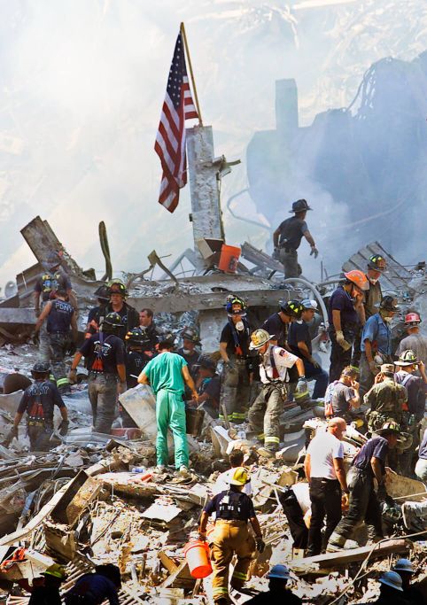 Rescue workers climb on piles of rubble at the World Trade Center in New York, Sept. 13, 2001. Beth A. Keiser | AP